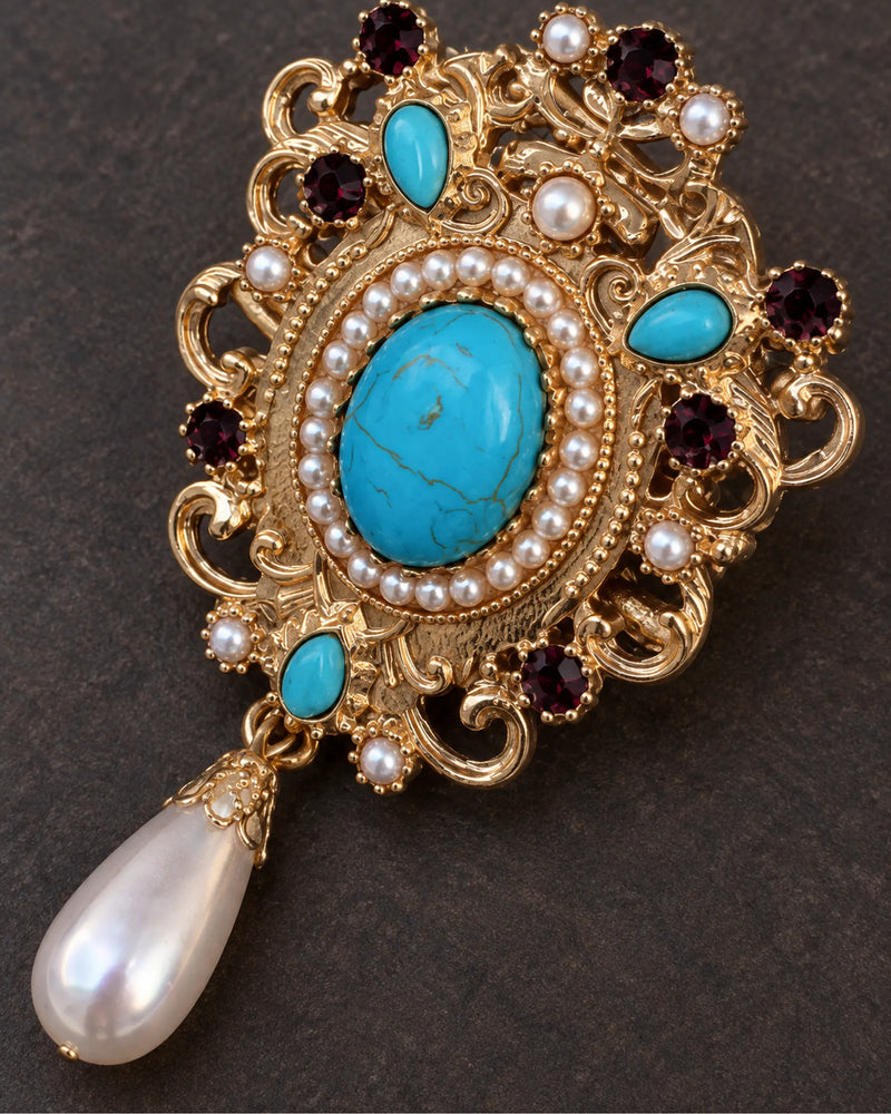 Tove Turquoise-Blue Scroll Drop Brooch — raised ornament and surface details, macro view