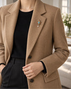 Tove Turquoise-Blue Scroll Drop Brooch — model wearing the brooch with a tailored outfit, wider view