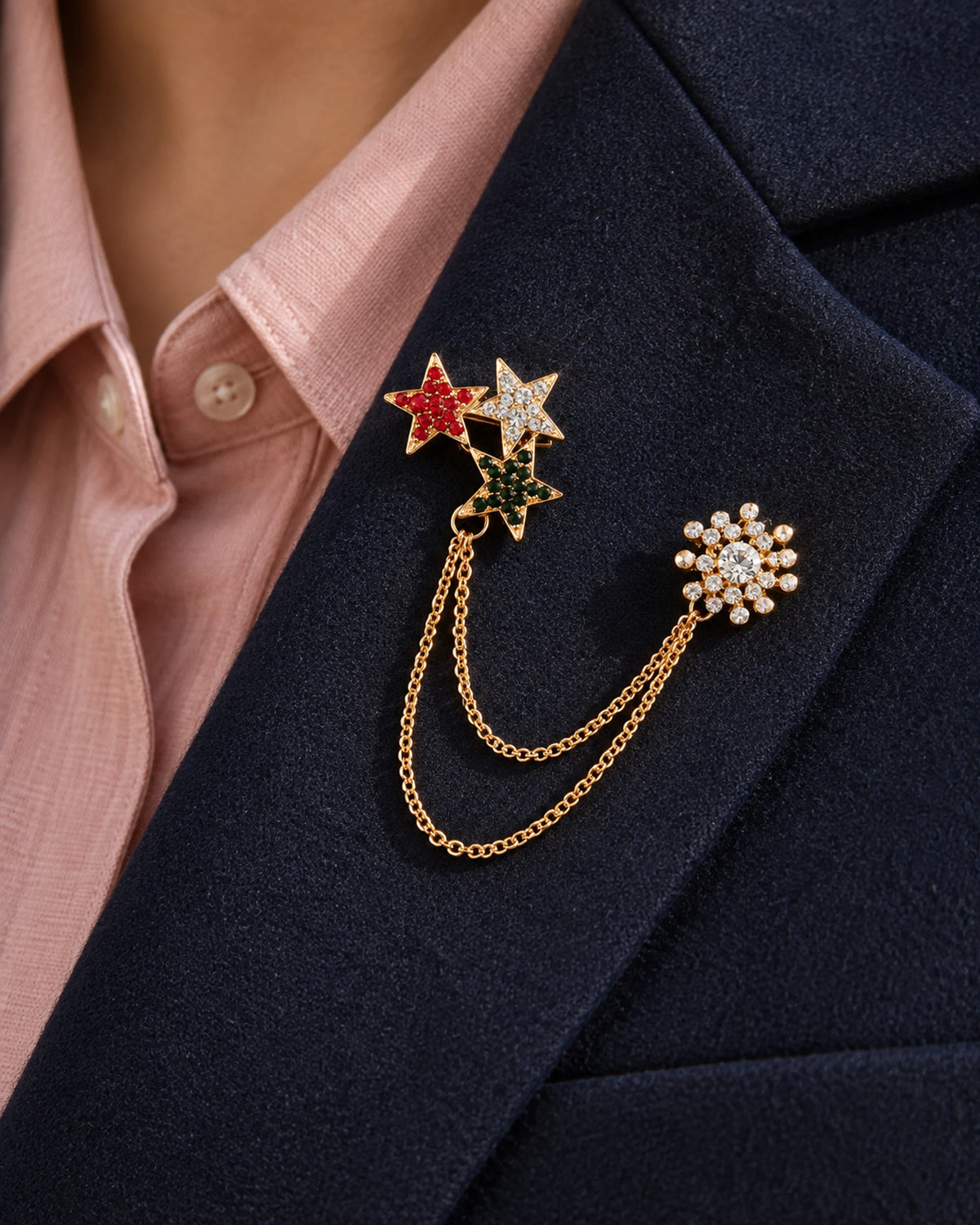 Tria Tricolor Star Lapel Chain Brooch in gold-tone finish; close wearing view on a structured lapel