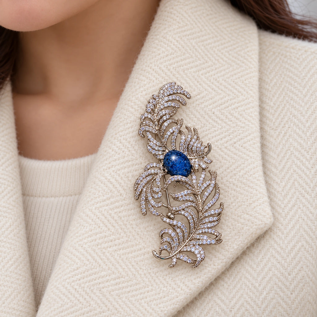 The complete feather scroll lies within one broad ivory herringbone lapel.