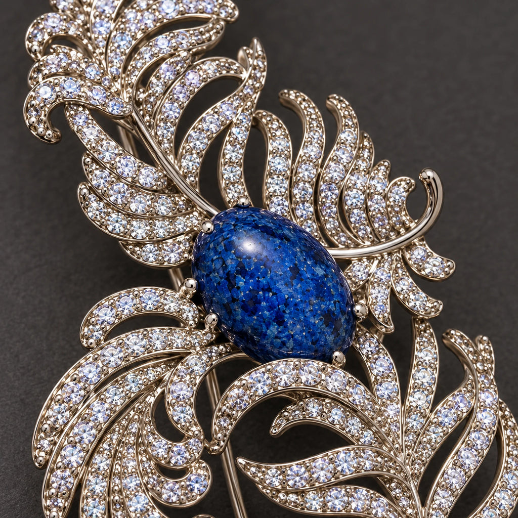 Small clear zircon follow the open ribs around the mottled deep-blue oval accent.