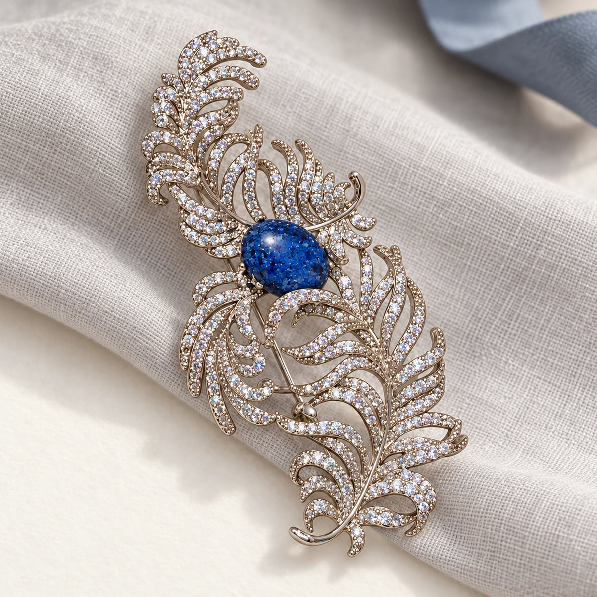 Complete Tuire Blue-Centre Zircon Feather Brooch in an original still life on paper and linen.