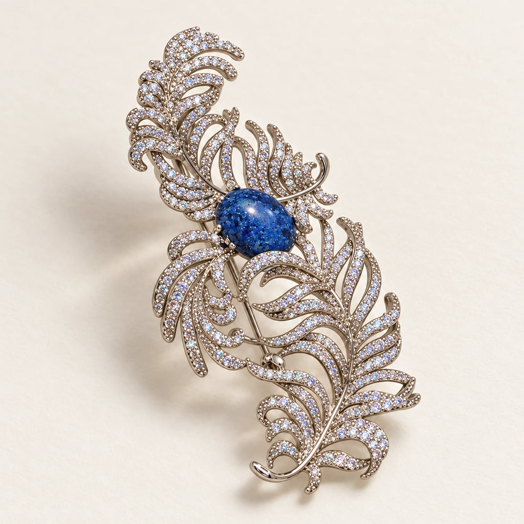 Tuire Blue-Centre Zircon Feather Brooch in a complete oblique front product display.