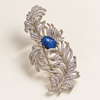 Tuire Blue-Centre Zircon Feather Brooch in a complete oblique front product display.