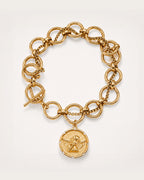 Onni Coin Charm Bracelet on a soft warm grey background