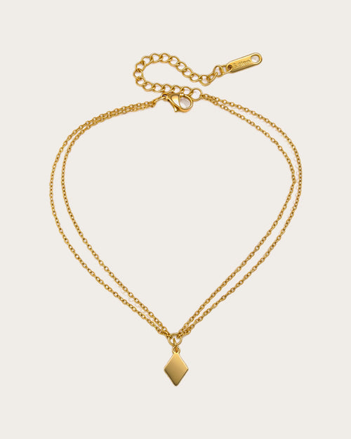 Aster Shore Pendant Anklet on a soft warm grey background