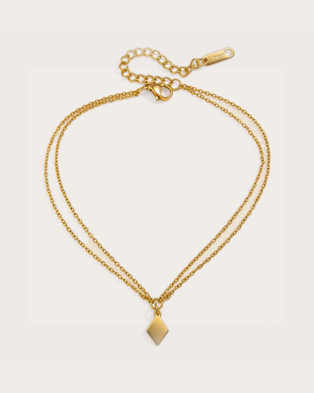 Aster Shore Pendant Anklet on a soft warm grey background