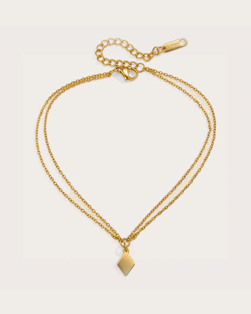 Aster Shore Pendant Anklet on a soft warm grey background
