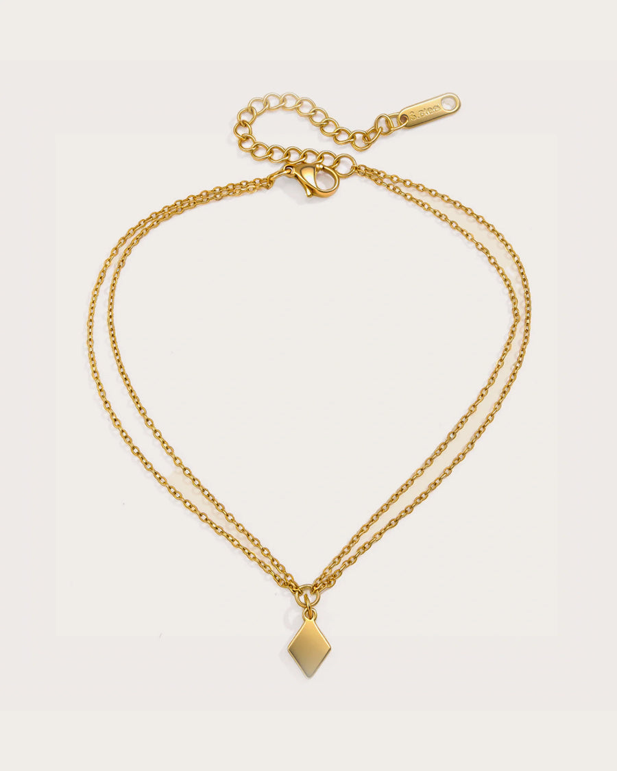 Aster Shore Pendant Anklet on a soft warm grey background