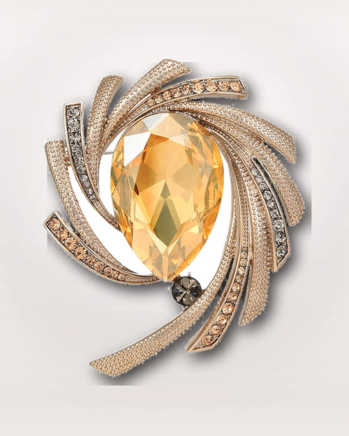 Astra Orbit Crystal Brooch on a soft warm grey background