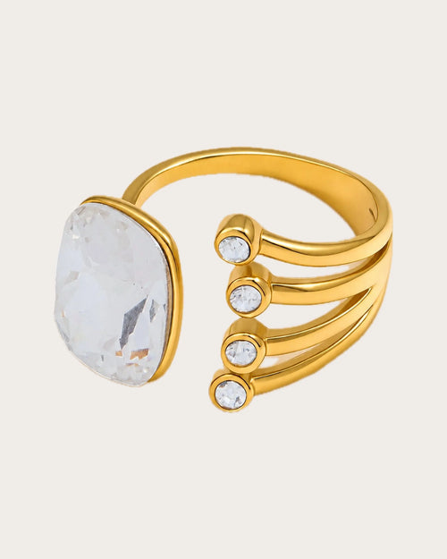 Atrium Adjustable Gold Crystal Ring on a soft warm grey background