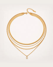 Säde Layered Gold Necklace on a soft warm grey background