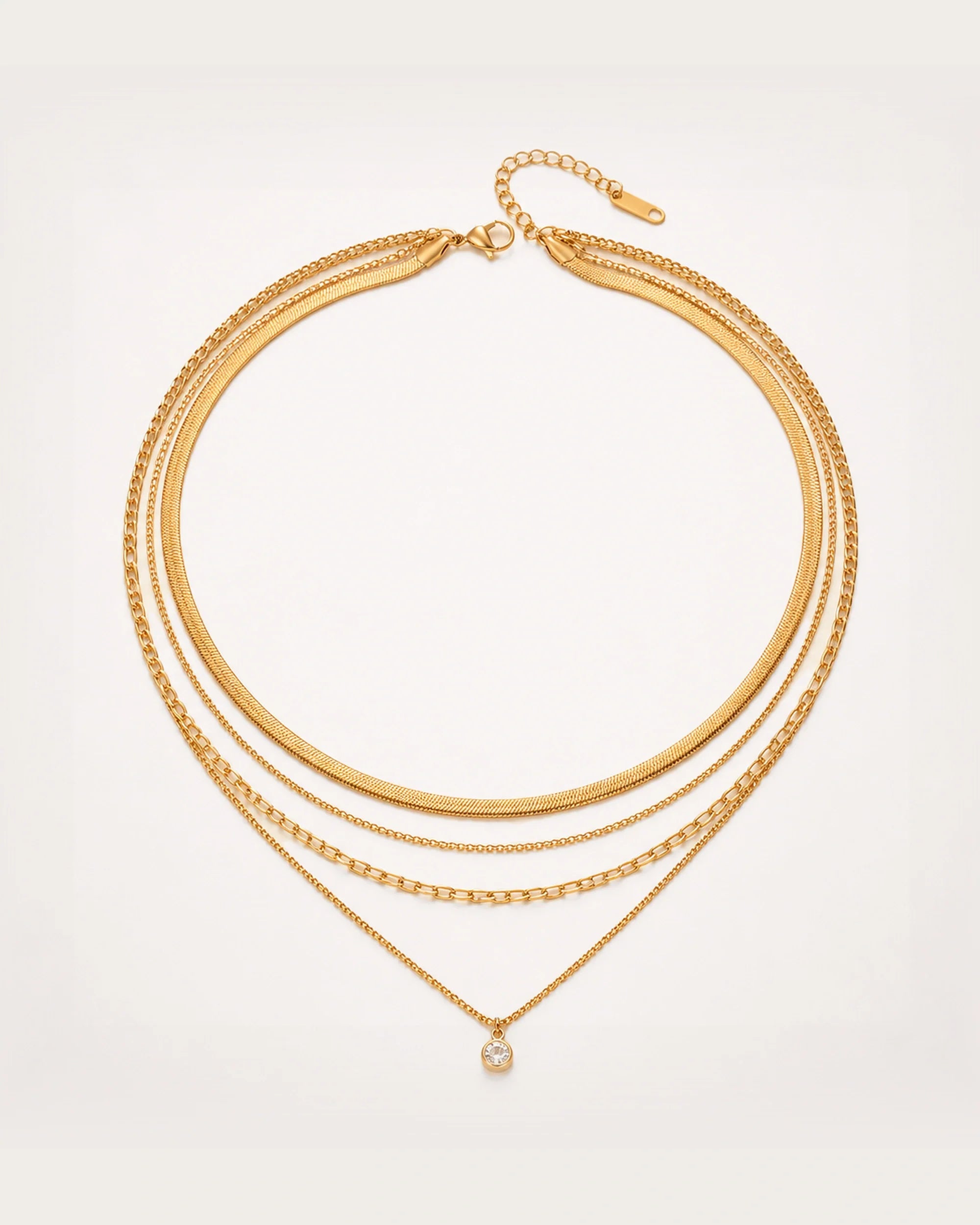 Säde Layered Gold Necklace on a soft warm grey background
