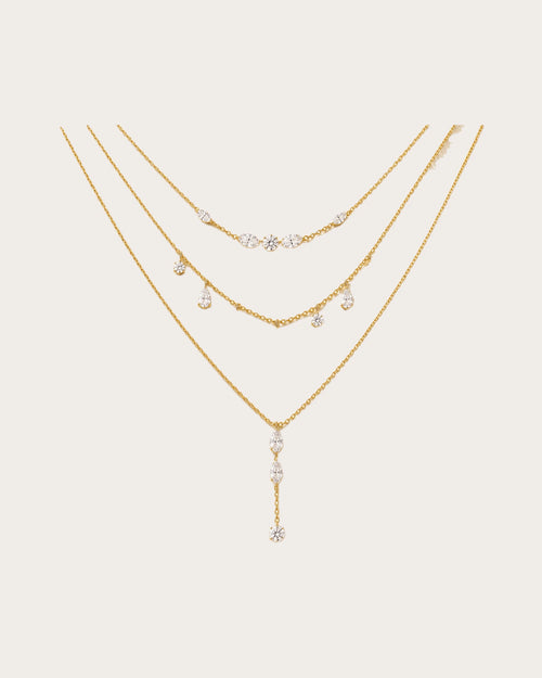 Aurelia Gold Layered Crystal Necklace Set on a soft warm grey background
