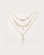 Aurelia Gold Layered Crystal Necklace Set on a soft warm grey background