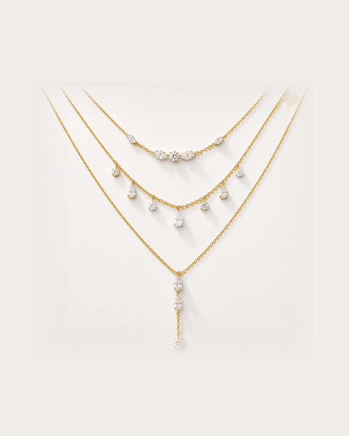 Aurelia Gold Layered Crystal Necklace Set on a soft warm grey background