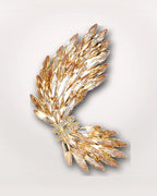 Aurelia Wing Crystal Brooch on a soft warm grey background