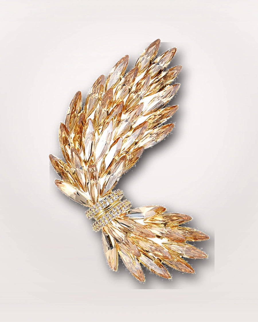 Aurelia Wing Crystal Brooch on a soft warm grey background