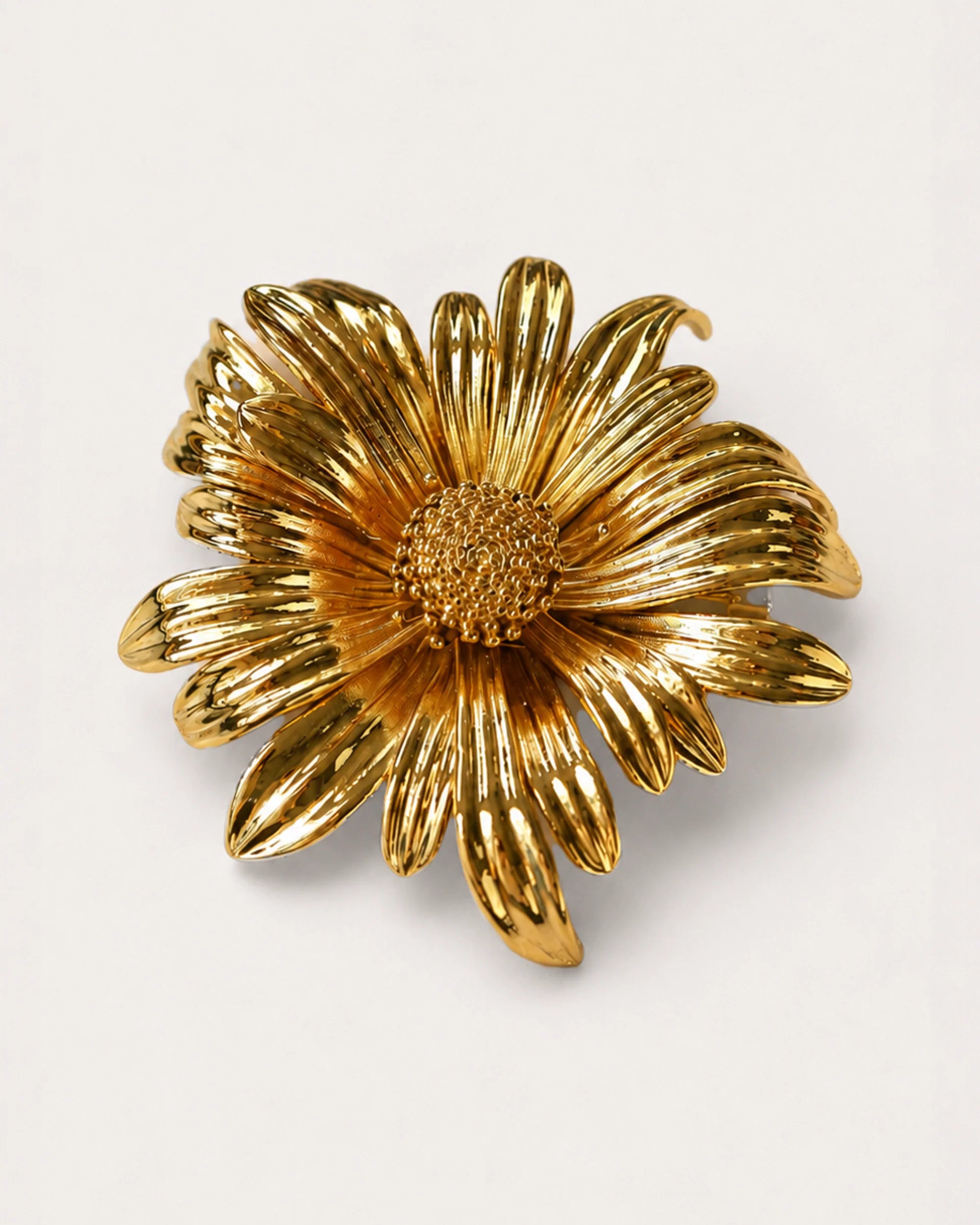 Aurinko Bloom Brooch on a soft warm grey background