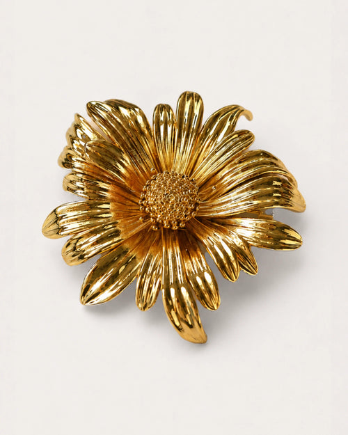 Aurinko Bloom Brooch on a soft warm grey background