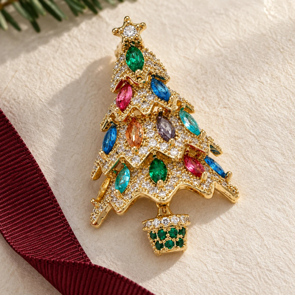 Kuusi Christmas tree brooch on ivory gift paper with burgundy ribbon
