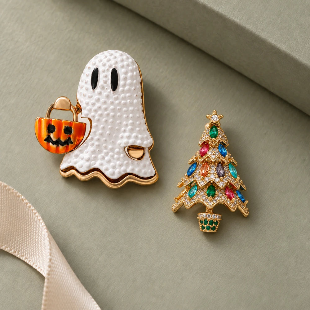 Usva ghost and Kuusi Christmas tree brooches on sage gift paper