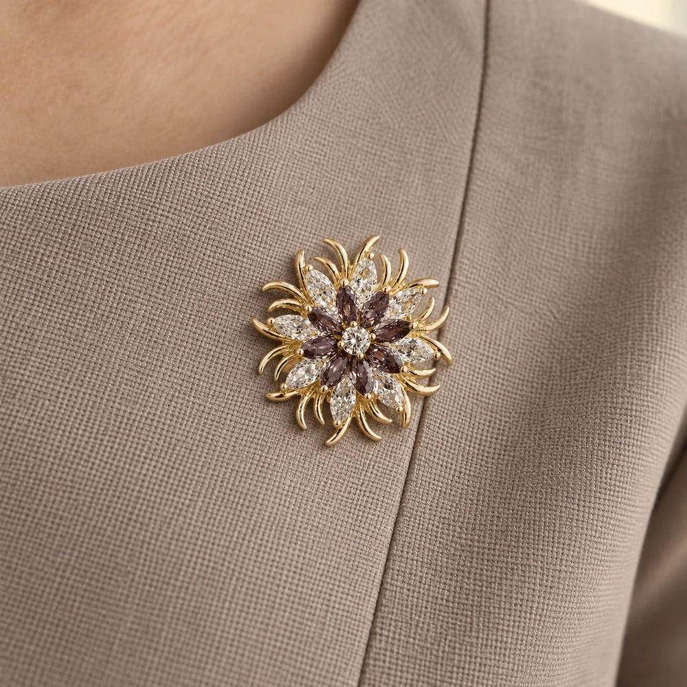 Meri purple and gold magnetic flower brooch on a taupe woven neckline