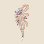 Elowen Crystal Spray Brooch in rose gold and lavender on an exact #EDE3D4 background