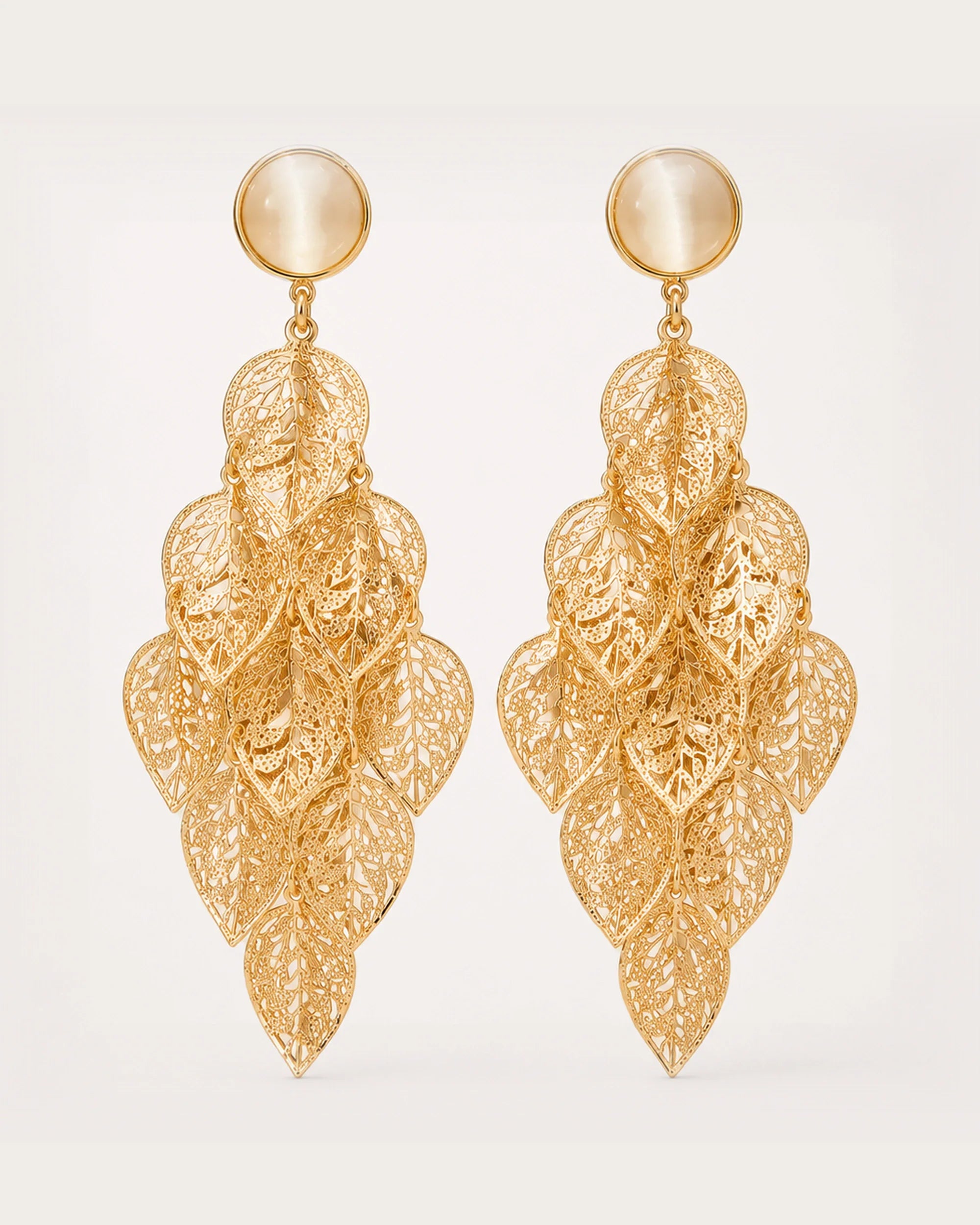 Lehti Gold Leaf Earrings on a soft warm grey background