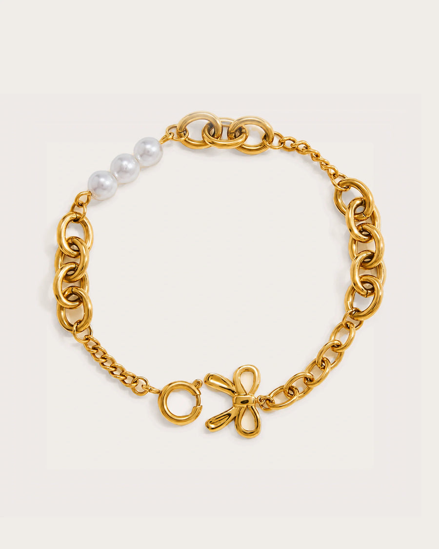 Helmi Pearl Heart Bracelet on a soft warm grey background