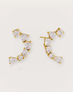 Ilo Smile Pavé Stud Earrings on a soft warm grey background