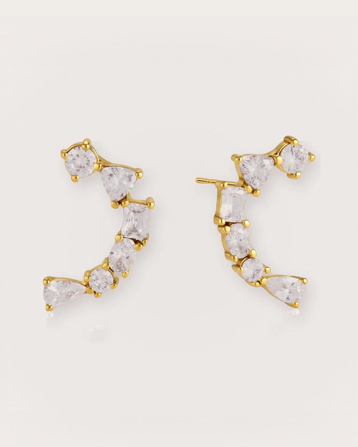 Ilo Smile Pavé Stud Earrings on a soft warm grey background