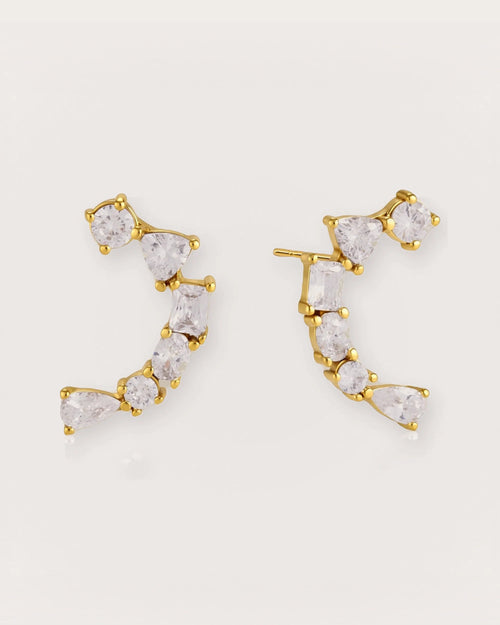 Ilo Smile Pavé Stud Earrings on a soft warm grey background