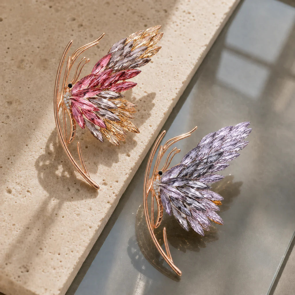 Pink and purple Isla Butterfly Brooch colorways arranged in a tactile still life