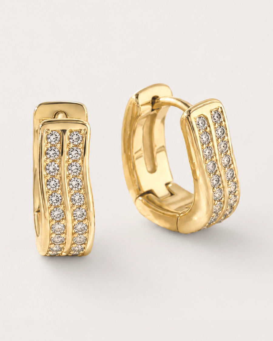Kide Double-Row Crystal Huggie Earrings on a soft warm grey background