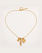 Lempi Daisy Charm Necklace on a soft warm grey background