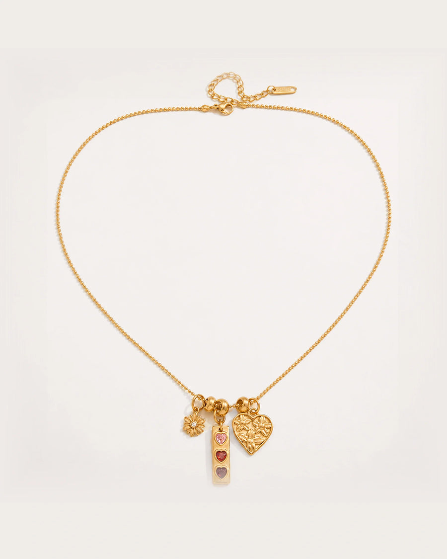 Lempi Daisy Charm Necklace on a soft warm grey background