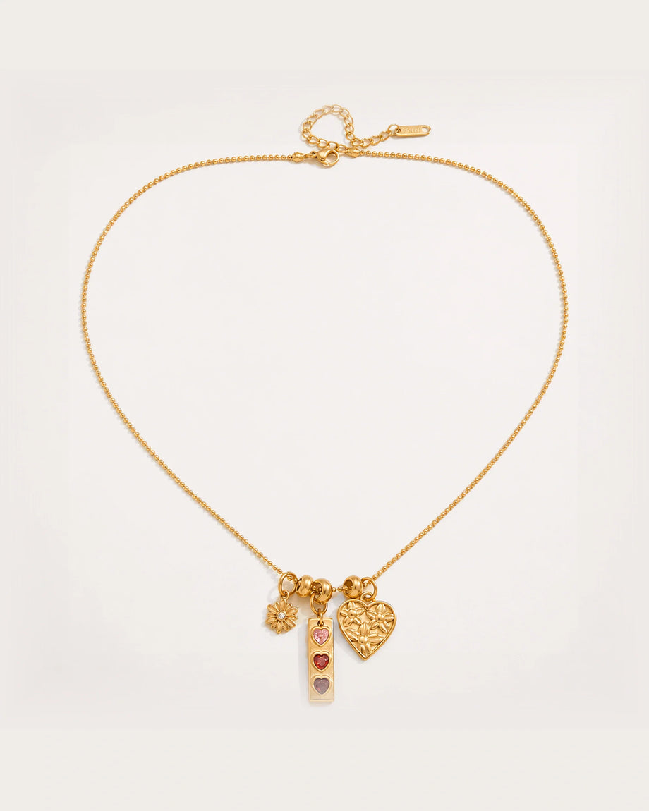 Lempi Daisy Charm Necklace on a soft warm grey background