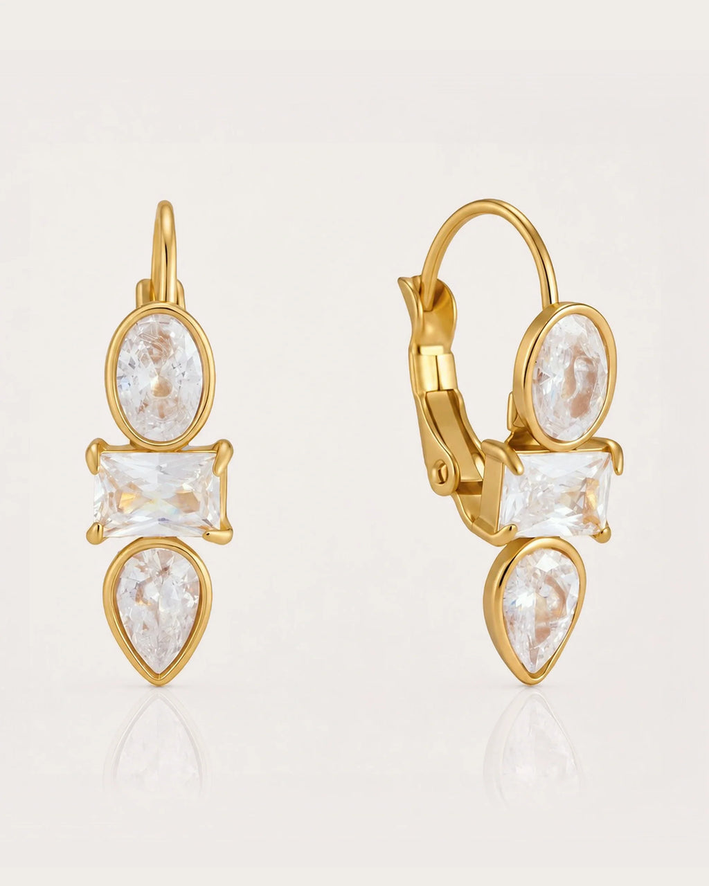 Liora Mixed-Cut Crystal Huggie Earrings on a soft warm grey background