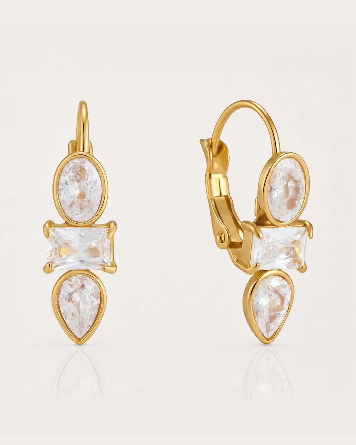 Liora Mixed-Cut Crystal Huggie Earrings on a soft warm grey background