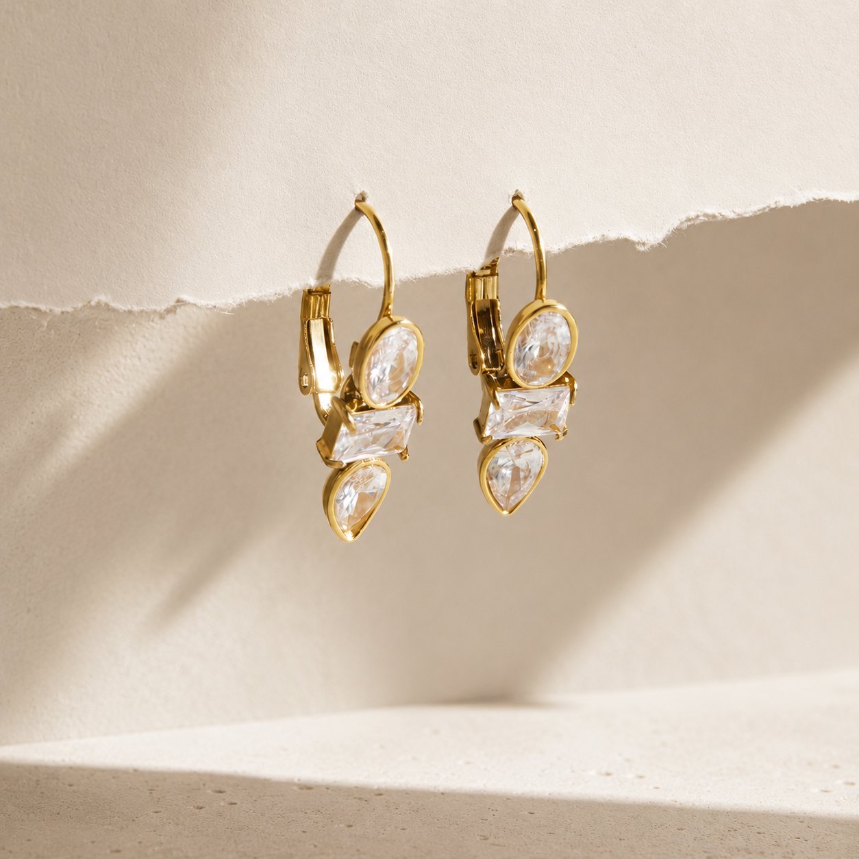 Gold crystal huggie earrings still life view