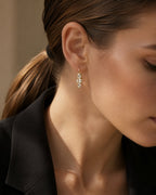 Gold crystal huggie earrings close-up wearing view
