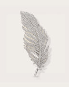 Lumi Crystal Feather Brooch on a soft warm grey background