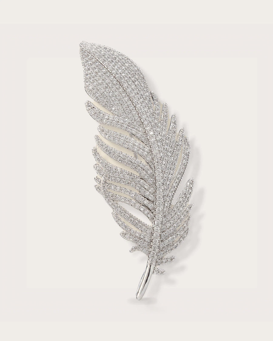 Lumi Crystal Feather Brooch on a soft warm grey background