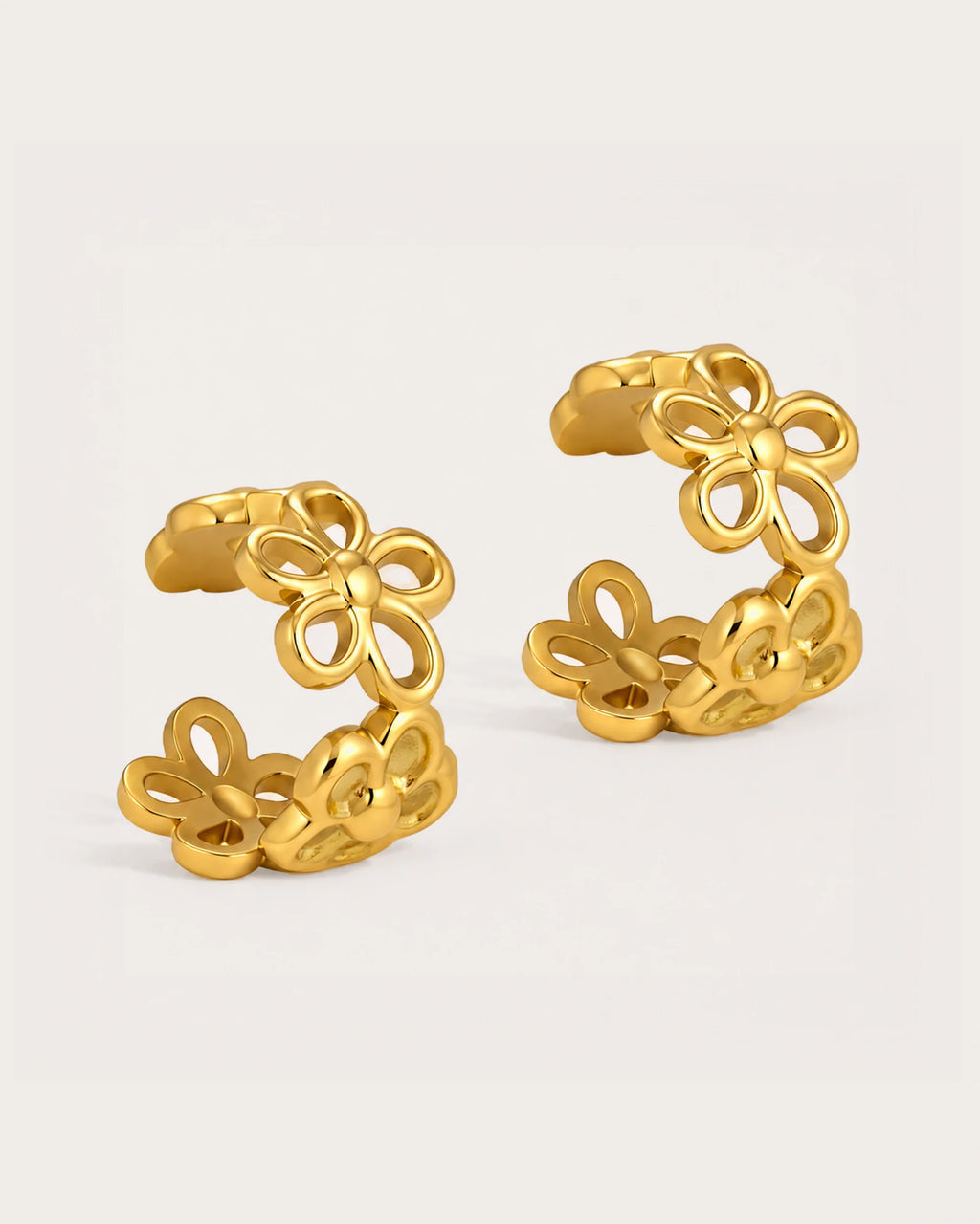 Lumme Bloom Ear Cuff Earrings on a soft warm grey background