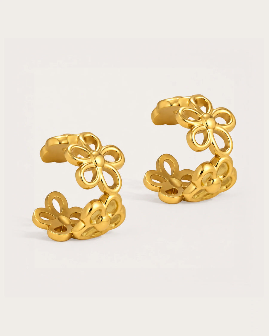 Lumme Bloom Ear Cuff Earrings on a soft warm grey background