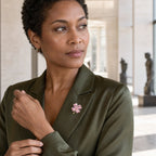 Woman wearing the Lykke Pink Clover Brooch on an olive silk blazer