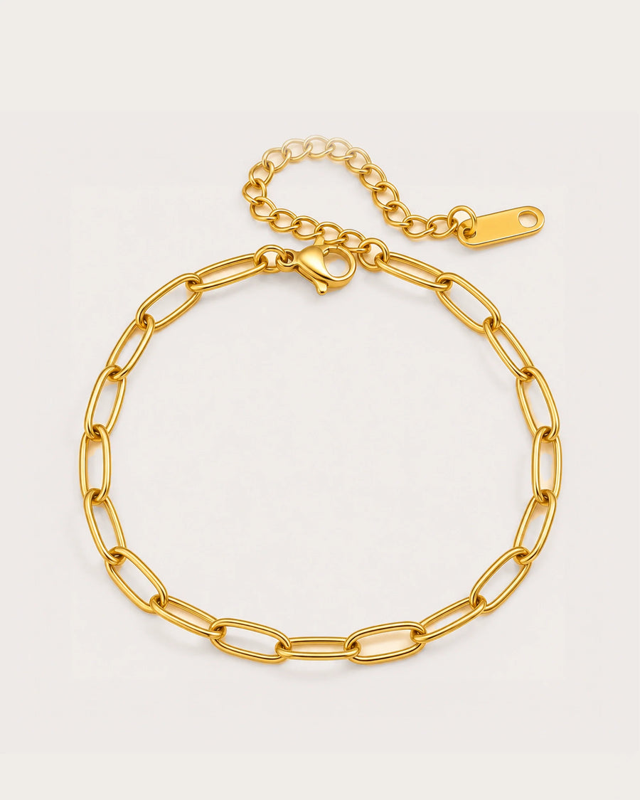 Lyra Gold Paperclip Chain Bracelet on a soft warm grey background