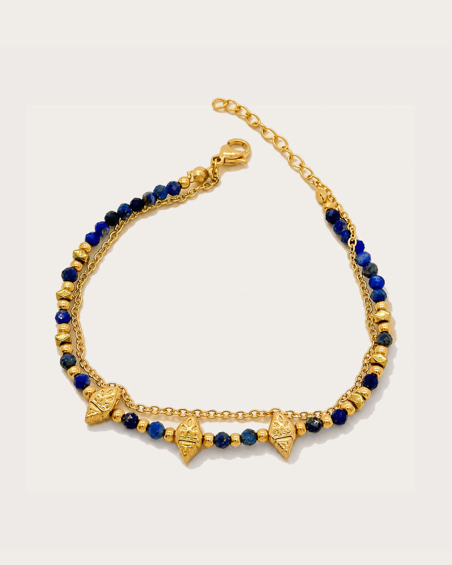 Nila Lapis Charm Bracelet on a soft warm grey background