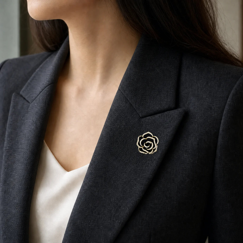 Noir Camellia Brooch worn on a charcoal blazer lapel